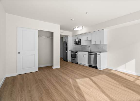 A kitchen with white cabinets and appliances is shown.