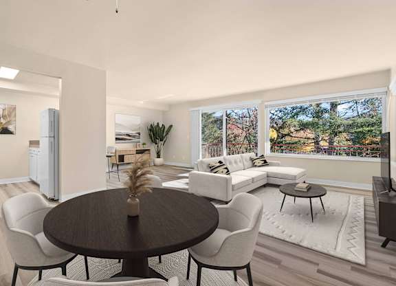 A modern dining room with a round table and chairs.