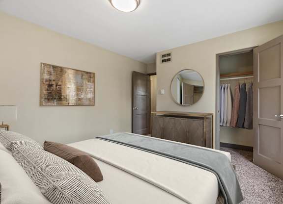 A bedroom with a bed, wardrobe, and a mirror.