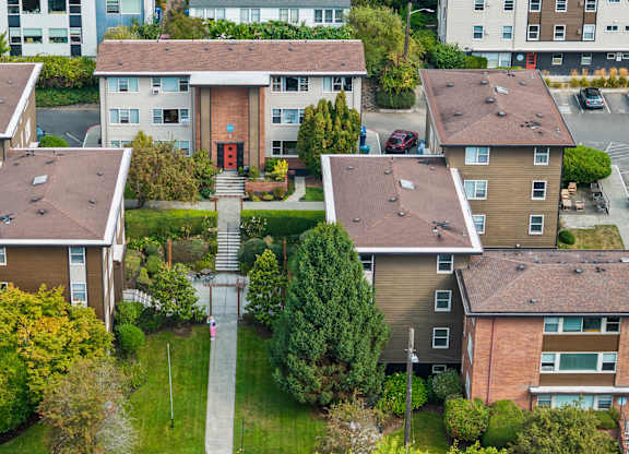 Apartment complex with a central courtyard and a red sign on the building.