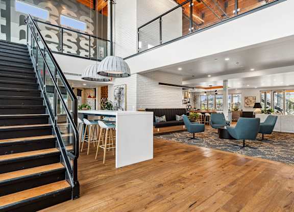 A modern open plan living and dining area with a staircase.