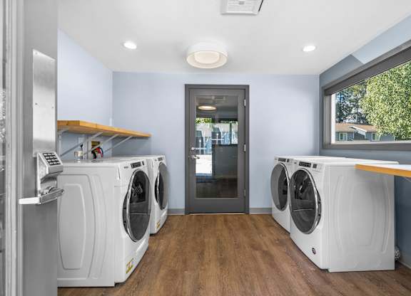 A laundry room with a washer and dryer in it.
