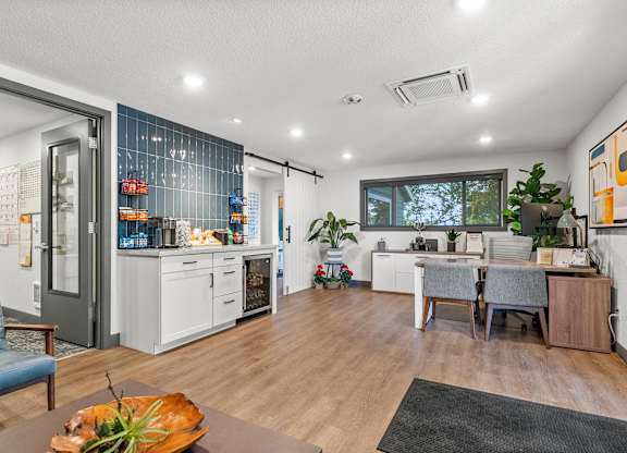 A modern kitchen with a dining table and chairs.