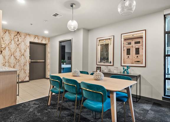 A dining room with a table set for four.