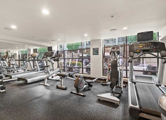 A gym with treadmills, exercise bikes, and other equipment.