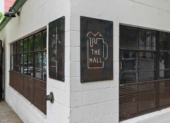 A white building with a sign that says