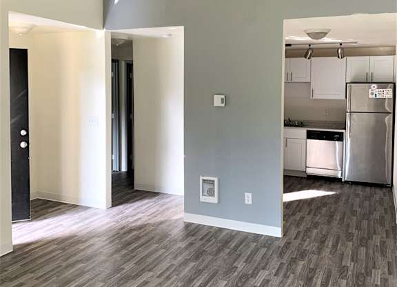 a view of the living room and kitchen from the dining room