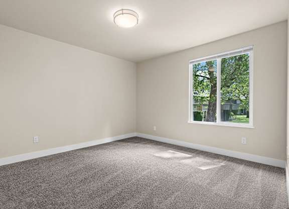 an empty room with carpet and a window at Bellamy Park Apartments , Lakewood, CA, 98498
