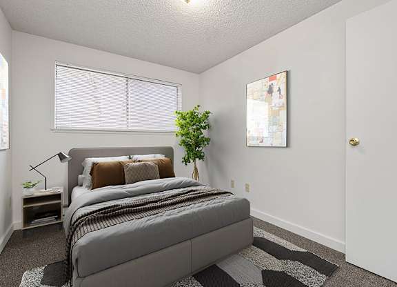 a bedroom with a bed and a window at The Verandas, Tacoma, 98466