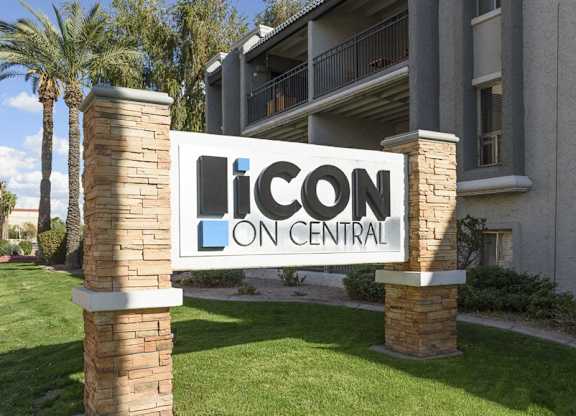 A sign that says Icon Central in front of a building.