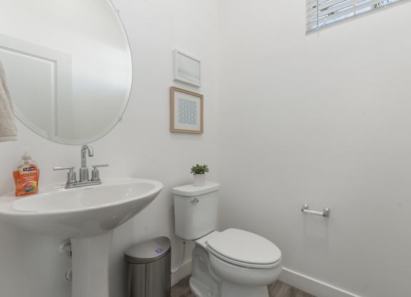A white toilet sits next to a sink in a bathroom.