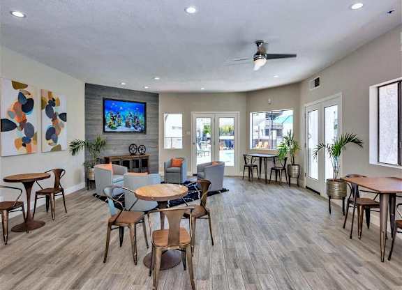 A spacious room with wooden floors and furniture.