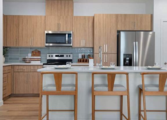 A kitchen with wooden cabinets and a white countertop.