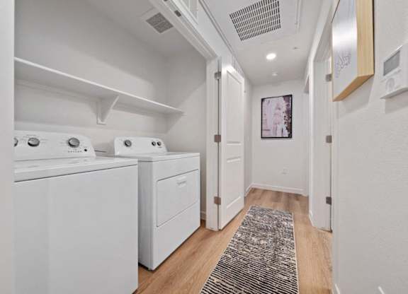 A laundry room with a washer and dryer.