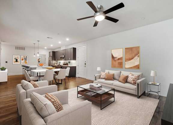 A modern living room with a grey sofa set and a wooden coffee table.
