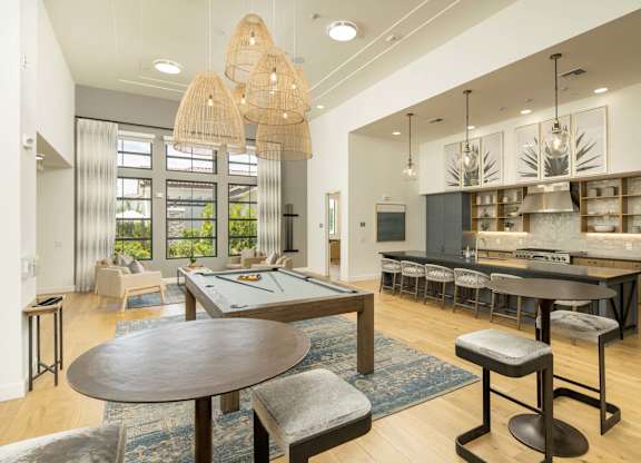 A modern dining room with a large table and chairs.