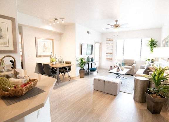 A living room with a dining table and chairs.