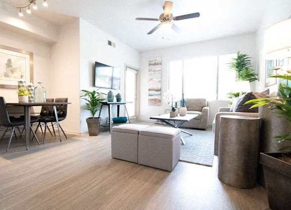 A living room with a dining table and chairs.