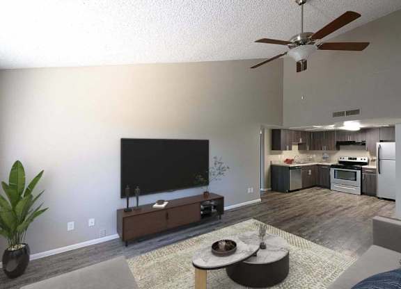 A living room with a television, a plant, and a couch.