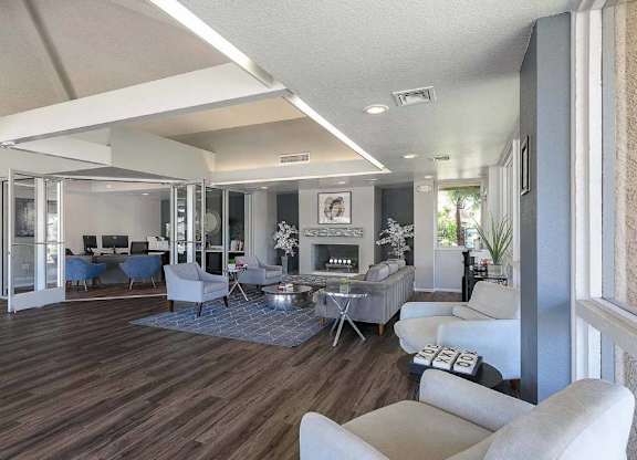 A living room with a fireplace and a dining table.
