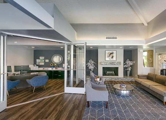 A modern living room with a fireplace and a dining area.