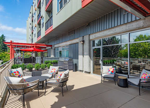 A red canopy over a patio with chairs and tables.