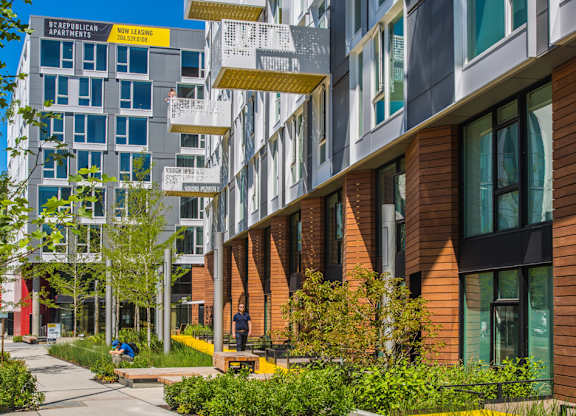 A modern apartment complex with a mix of brick and glass buildings.