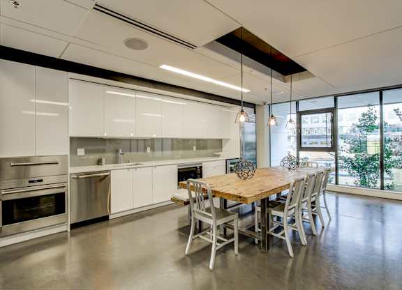 A modern kitchen with a dining table and chairs.