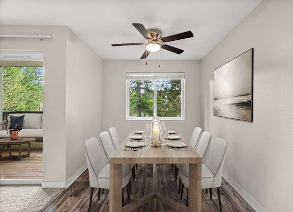 A dining room with a wooden table and chairs.