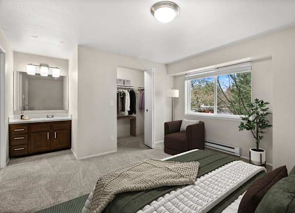 A bedroom with a bed, chair, and closet.