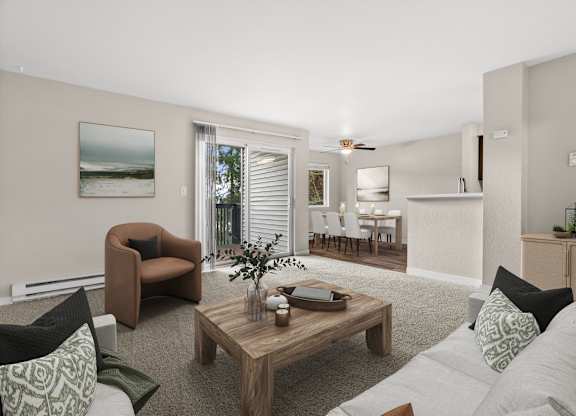 A living room with a brown chair, a coffee table, and a painting on the wall.