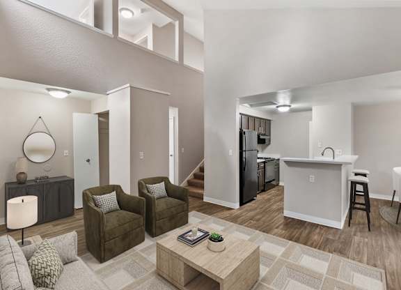 A modern living room with a kitchen in the background.