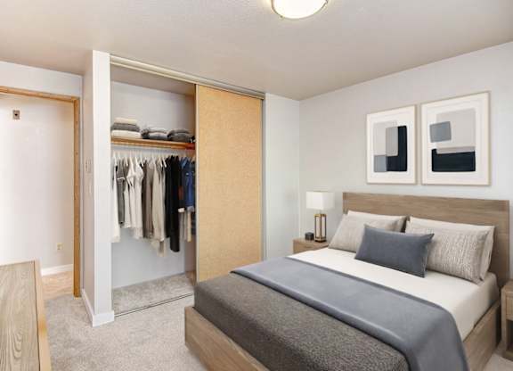 A bedroom with a large bed and a wardrobe.