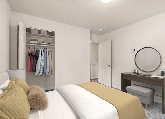 A bedroom with a bed, desk, and wardrobe.