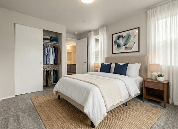 A bedroom with a large bed and a wardrobe.