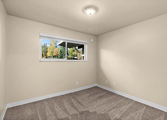 an empty room with carpet and a window