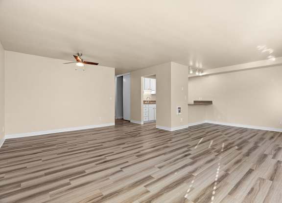 the living room with hardwood floors and a ceiling fan