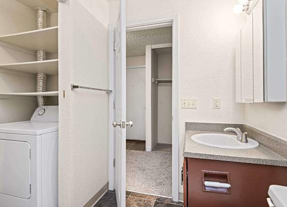 A white washer and dryer are in a small laundry room. at Brookstone, SeaTac, WA, 98198