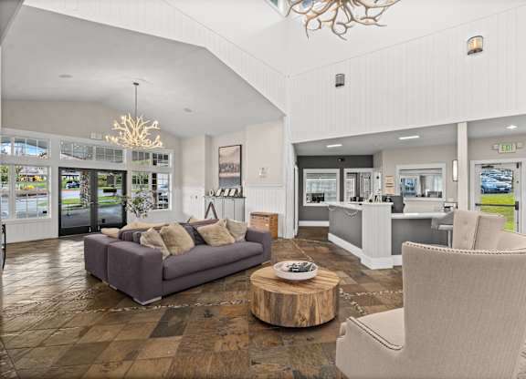 A living room with a grey couch and a wooden coffee table.