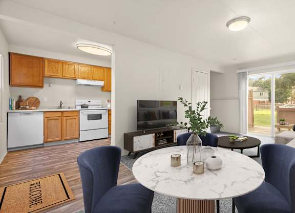 A modern kitchen with a dining table set for two.