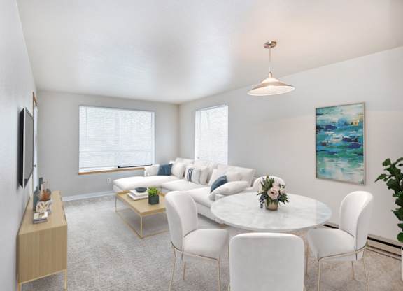 A living room with a white couch and a coffee table.