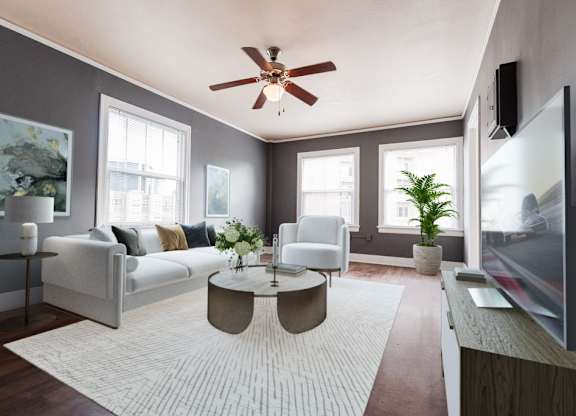 a living room with a white rug and a ceiling fan at Edwards on Fifth, Seattle, Washington