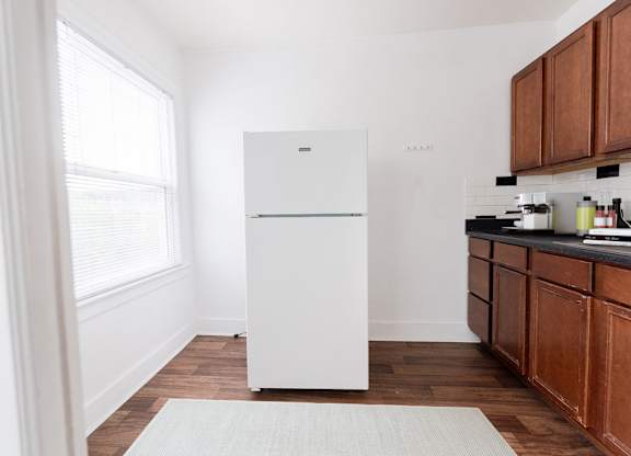 a kitchen with a white refrigerator and wooden cabinets at Edwards on Fifth, Washington, 98121