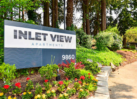 a sign at the entrance to the inlet view apartments