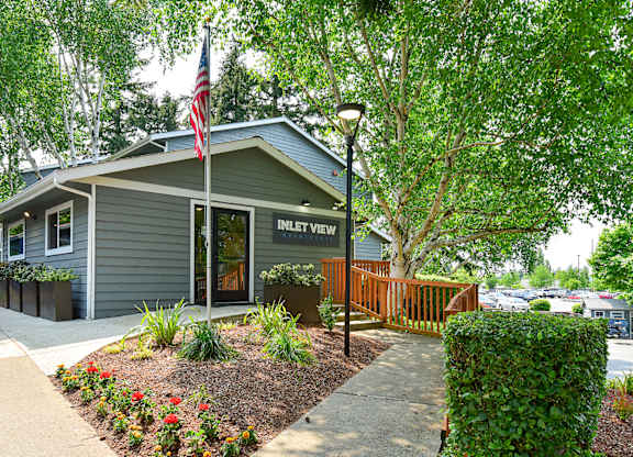 a gray building with an american flag in front of it
