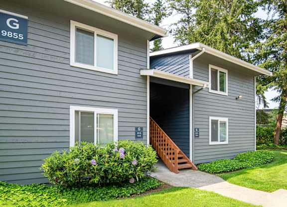 a blue house with an open garage door