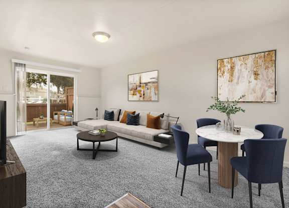A living room with a grey carpet and a white table.
