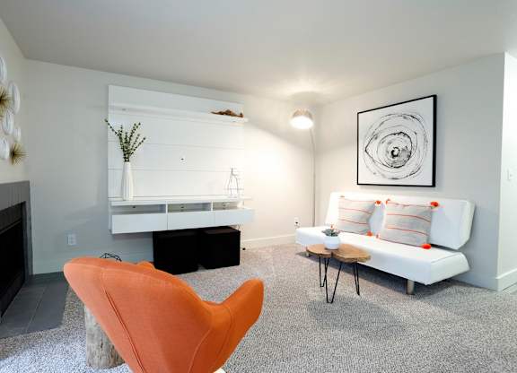 a living room with a white couch and a fireplace at Northpoint Apartments, Tacoma, WA, 98407