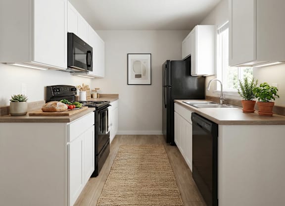 A kitchen with black appliances and white cabinets.
