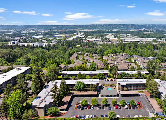 A large building with a parking lot in front of it.